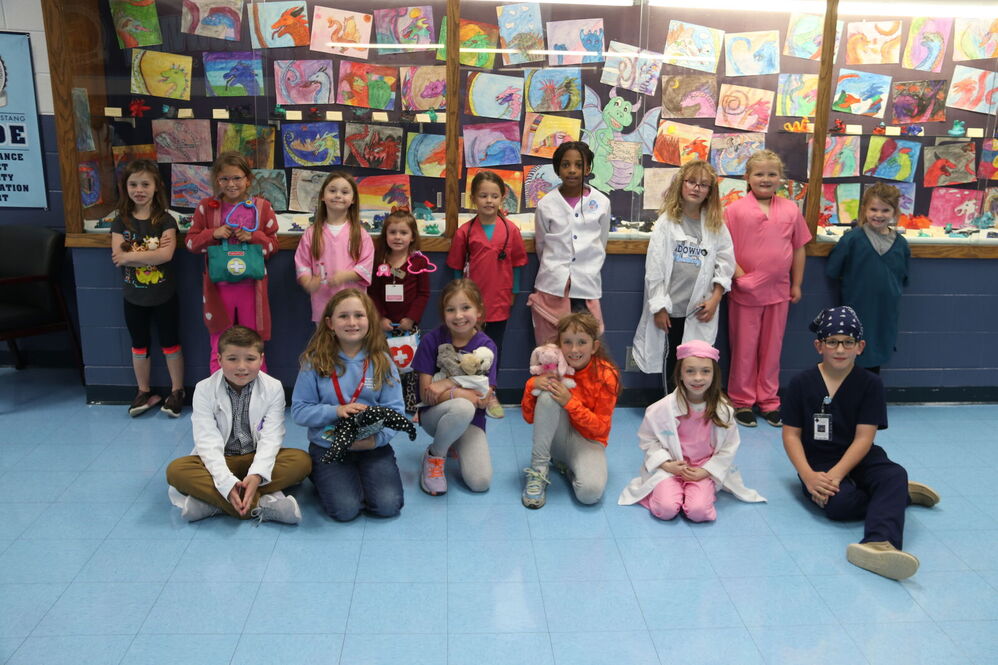 Group of kids in front of art wall