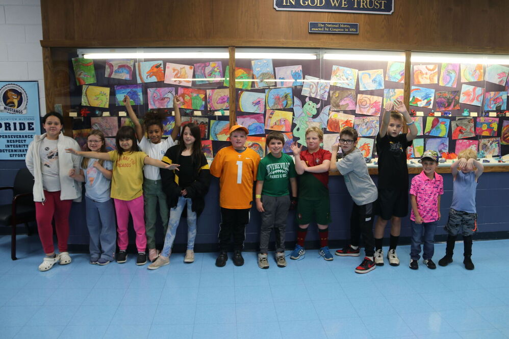 Group of kids in front of art wall