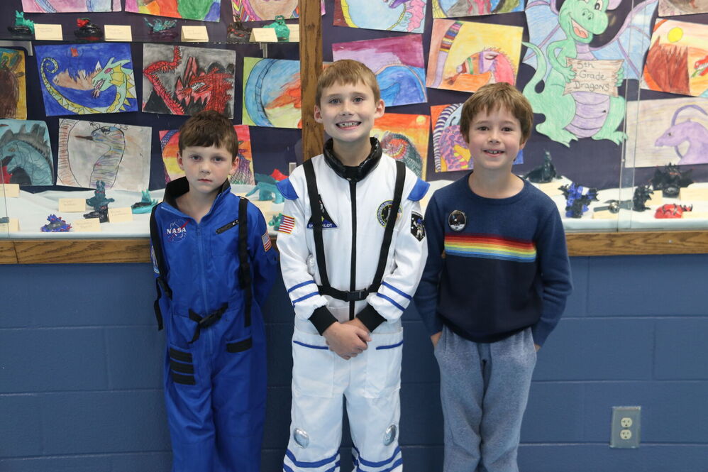 SGroup of kids in front of art wall